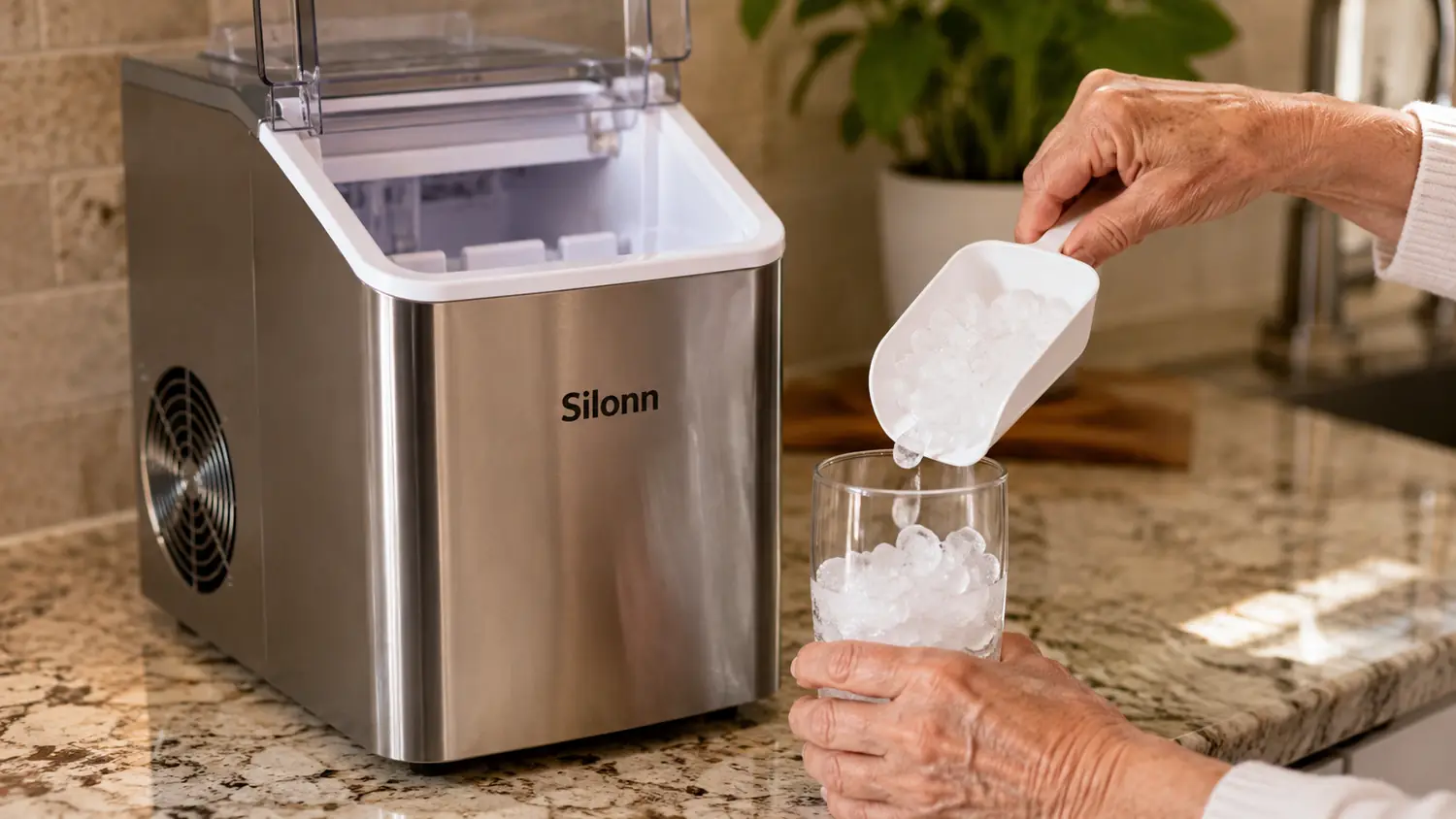 Hand scooping soft nugget ice from the Silonn ice maker basket into a glass